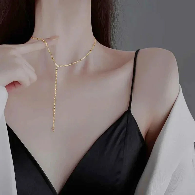 LuxeTassel Necklace – Double Layer Chain Choker  Layered shine. Flowing detail. Effortless elegance.