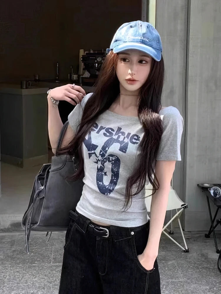 SportMuse Off-Shoulder Tee – Y2K Vintage Crop Top  Sporty edge. Vintage vibe. Effortless confidence.