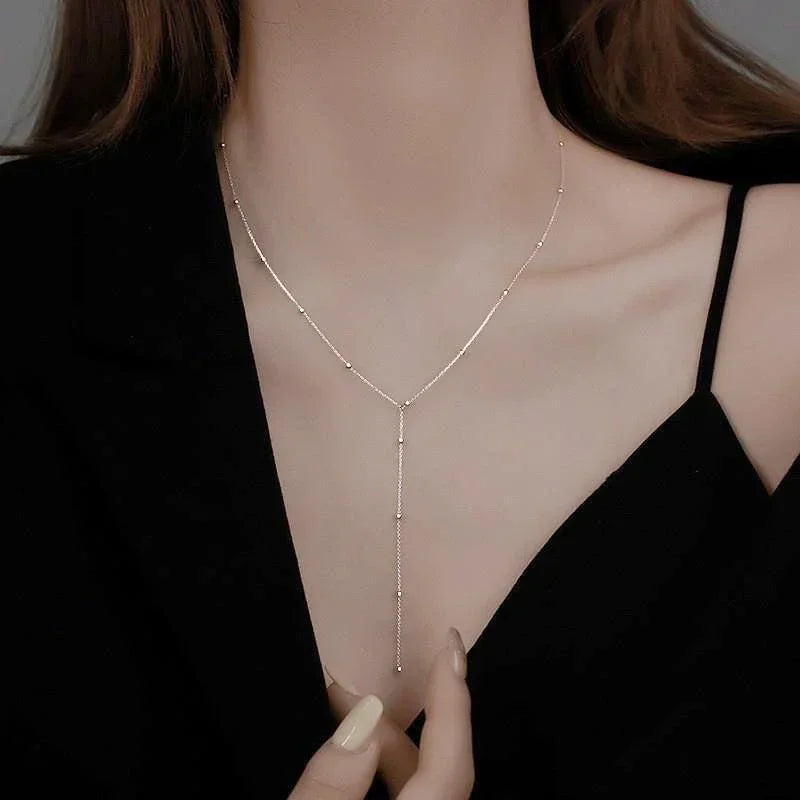 LuxeTassel Necklace – Double Layer Chain Choker  Layered shine. Flowing detail. Effortless elegance.